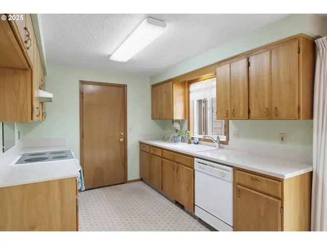 a kitchen with a sink and large window