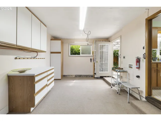 a kitchen with refrigerator and cabinets