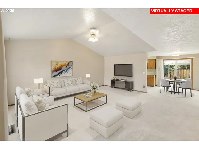 a view of an empty room with chandelier fan