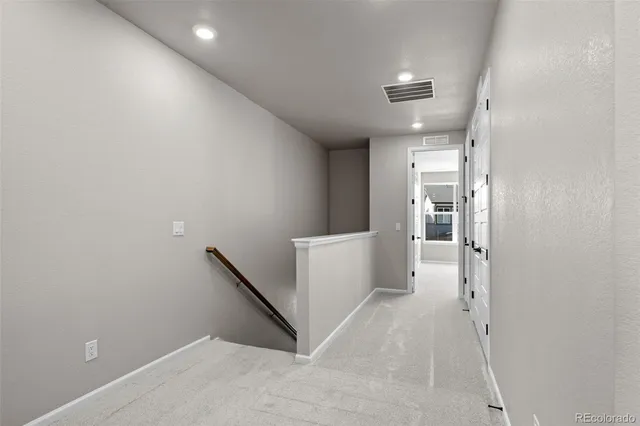 a view of a hallway with stairs