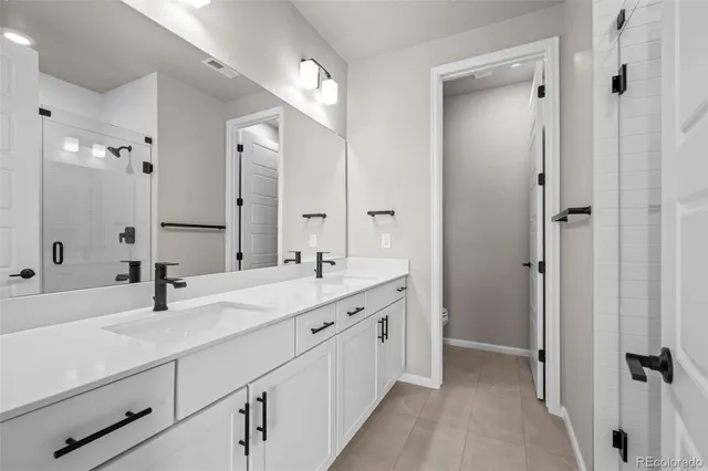 a bathroom with a double vanity sink mirror and