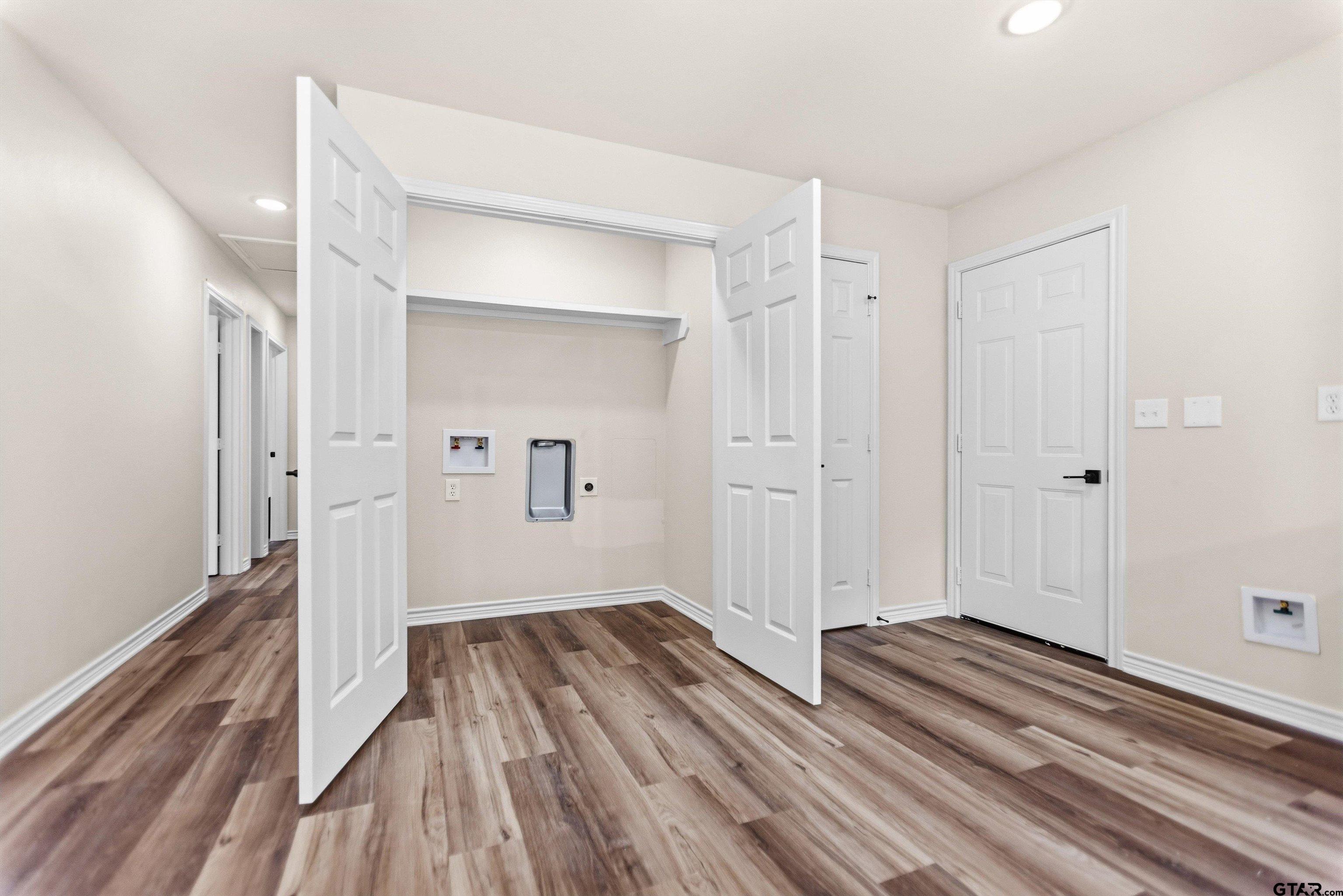 22463 Trailwood Road Flint, TX 75762 - Photo 6 of 17 a view of a room with wooden floor and a bathroom