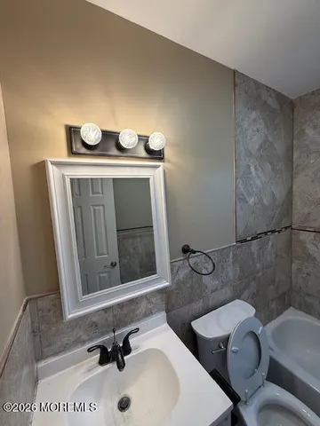 a view of empty room with wooden floor and stairs