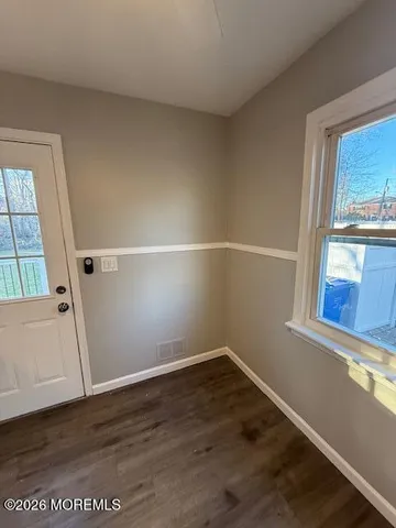a view of a small space with wooden floor and staircase