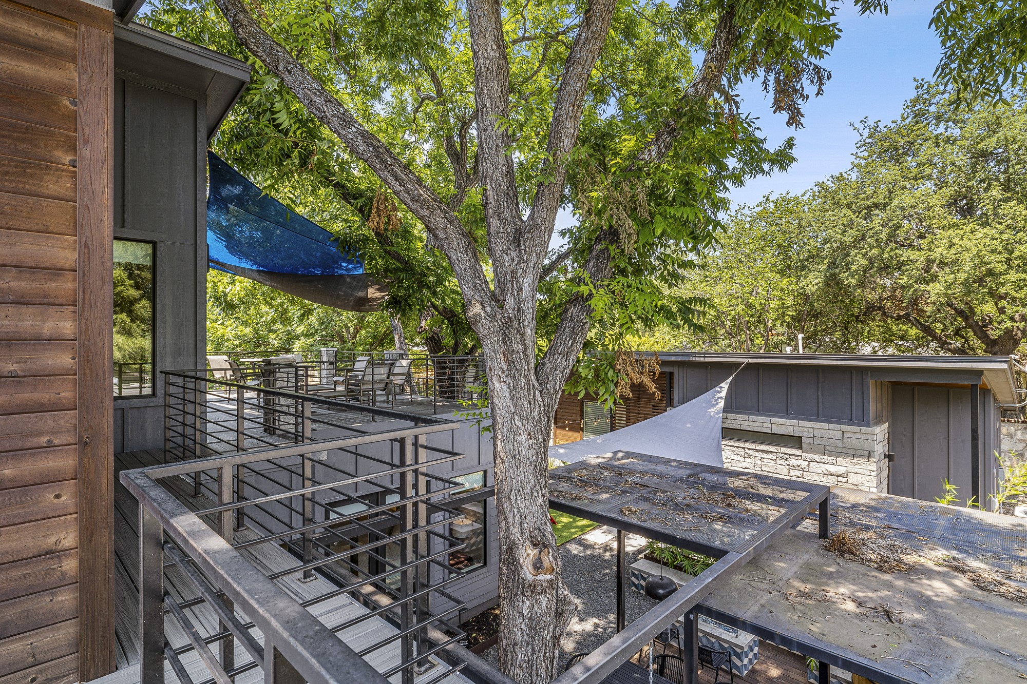 2414 Kinney Road Austin, TX 78704 - Photo 25 of 40 a view of a roof deck with wooden fence and a couple of chairs
