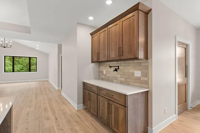 a large white kitchen with a large window