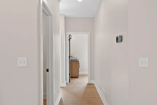 an empty room with fan and windows