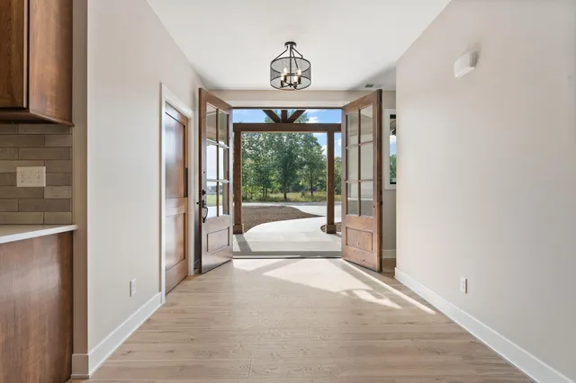 a spacious bedroom with a large window and a bed