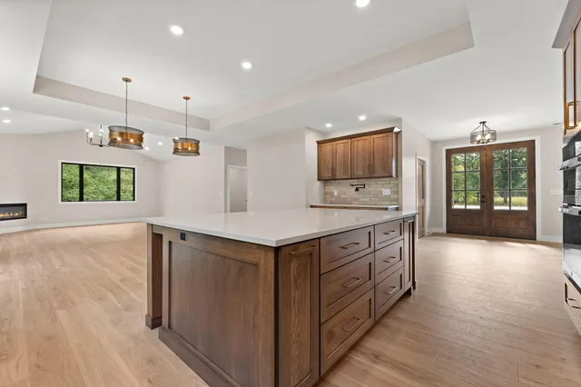 a view of a room that has a window and wooden floor