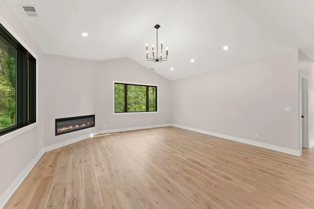 a kitchen with a sink a counter top space stainless steel appliances and a large window