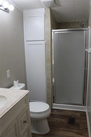 a bathroom with a granite countertop sink and shower