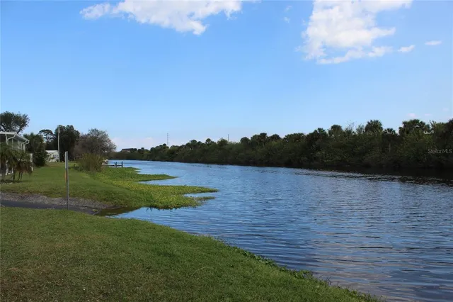 a view of a lake with a yard