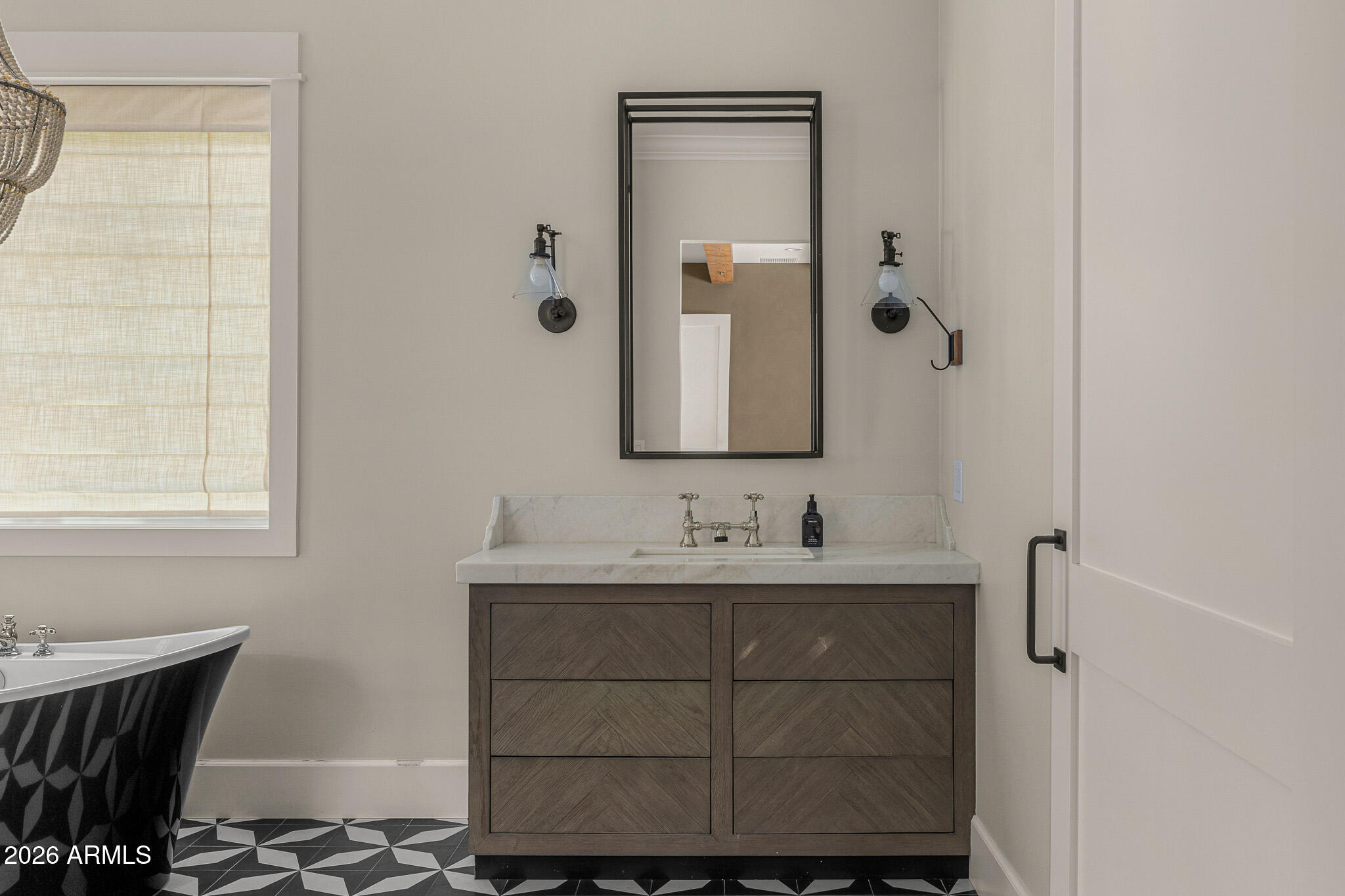 4204 North 57th Way Phoenix, AZ 85018 - Photo 19 of 34 a bathroom with a sink and a mirror