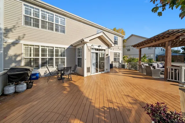 a view of a patio with chairs and potted plants