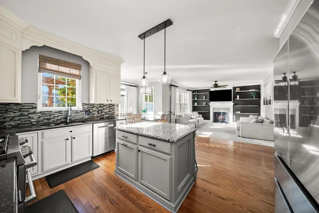 a kitchen with stainless steel appliances granite countertop a stove and cabinets