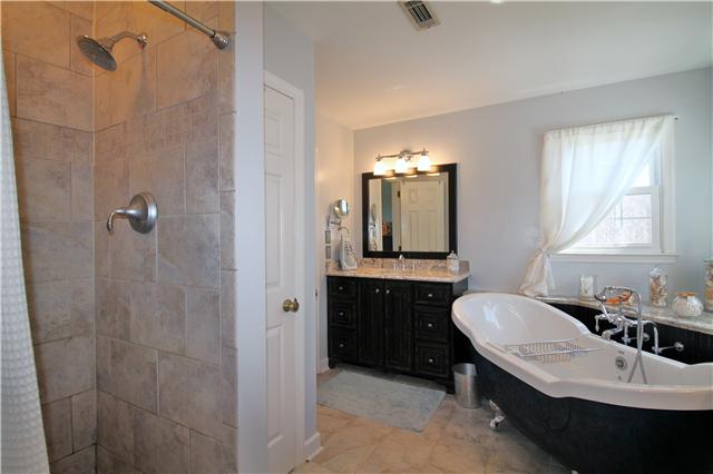 5902 Parham Road Franklin, TN 37064 - Photo 14 of 20 a bathroom with a double vanity sink mirror and bathtub