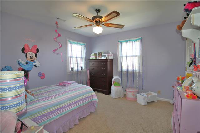 5902 Parham Road Franklin, TN 37064 - Photo 15 of 20 a bedroom with a bed and a chandelier