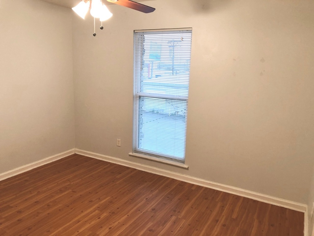 2301 Ohlen Road, Unit 213 Austin, TX 78757 - Photo 5 of 12 Empty room featuring dark wood-type flooring and ceiling fan