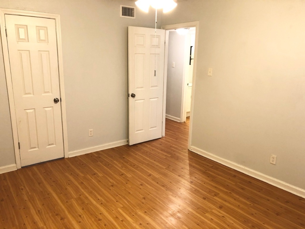2301 Ohlen Road, Unit 213 Austin, TX 78757 - Photo 7 of 12 Spare room featuring wood finished floors and baseboards