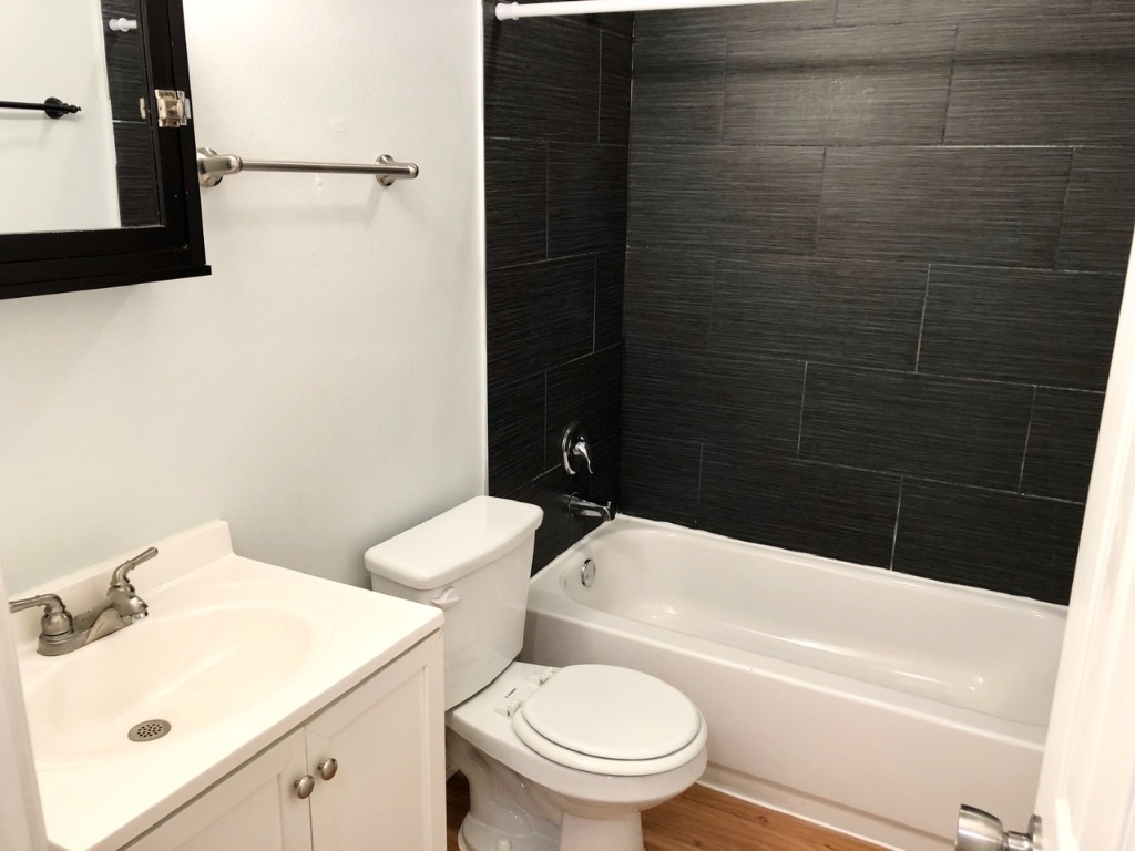 2301 Ohlen Road, Unit 213 Austin, TX 78757 - Photo 9 of 12 Full bathroom with vanity, bathtub / shower combination, and wood finished floors
