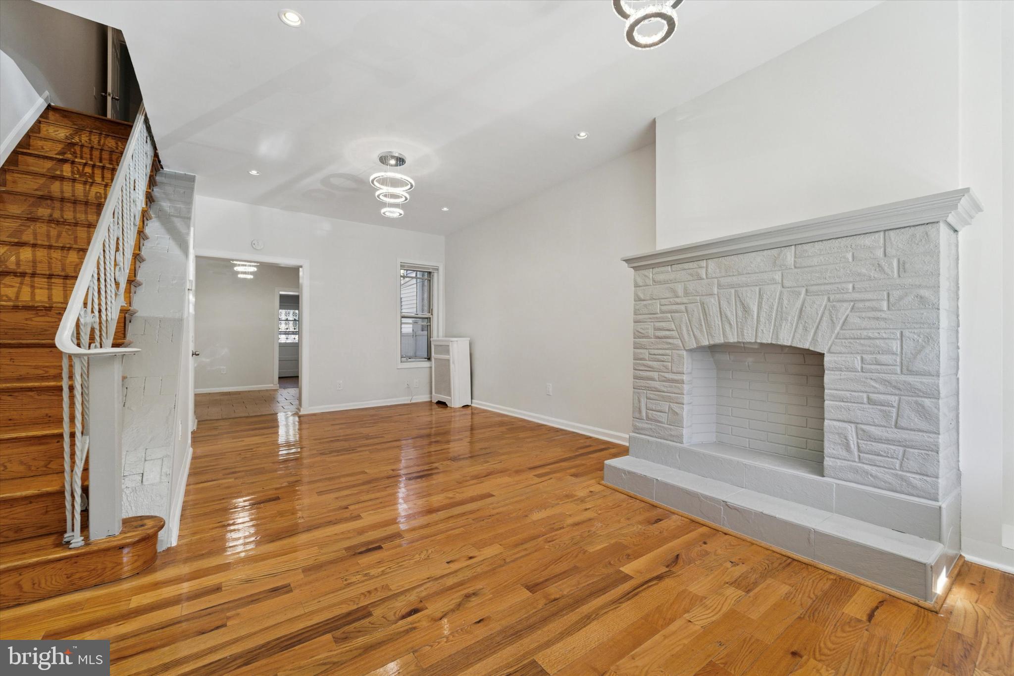 3052 Aramingo Avenue Philadelphia, PA 19134 - Photo 1 of 24 an empty room with wooden floor and fireplace
