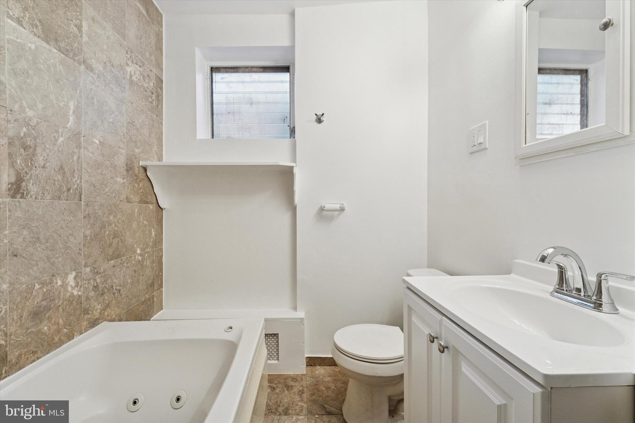 3052 Aramingo Avenue Philadelphia, PA 19134 - Photo 14 of 24 a bathroom with a sink toilet and shower