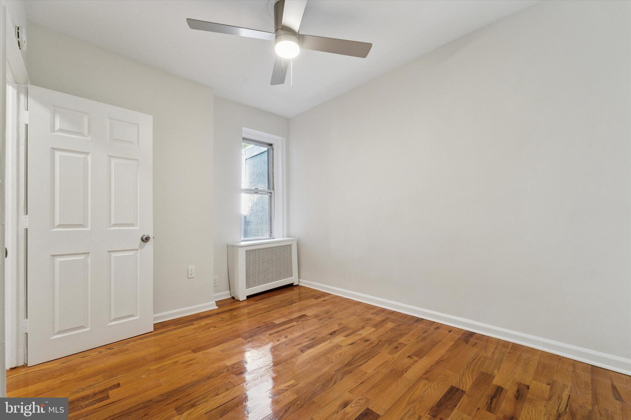 3052 Aramingo Avenue Philadelphia, PA 19134 - Photo 16 of 24 a view of empty room with wooden floor and fan
