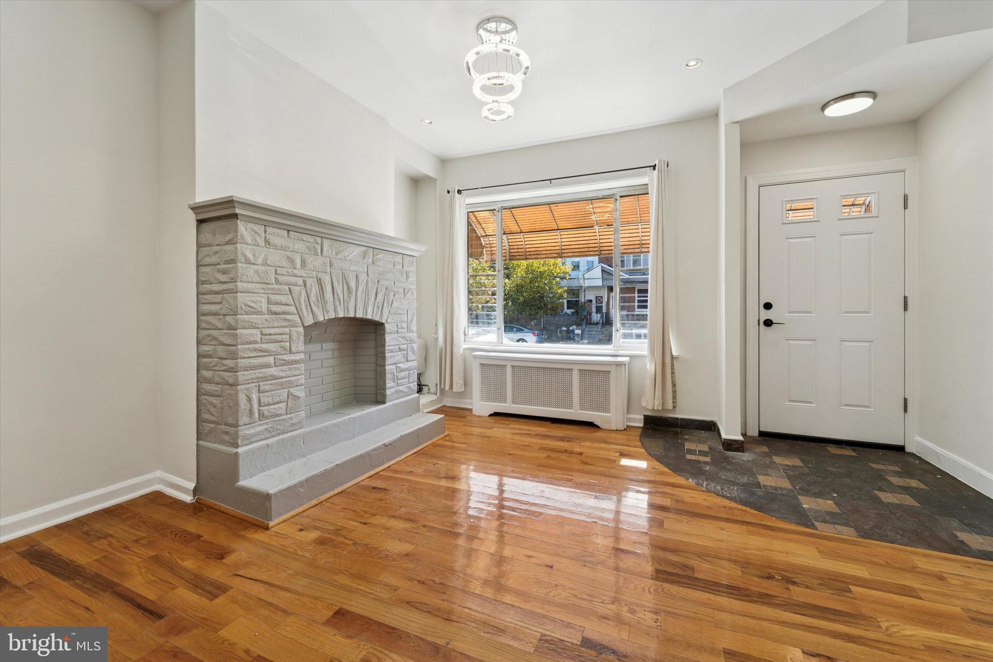 3052 Aramingo Avenue Philadelphia, PA 19134 - Photo 4 of 24 a view of an empty room with a fireplace and a window