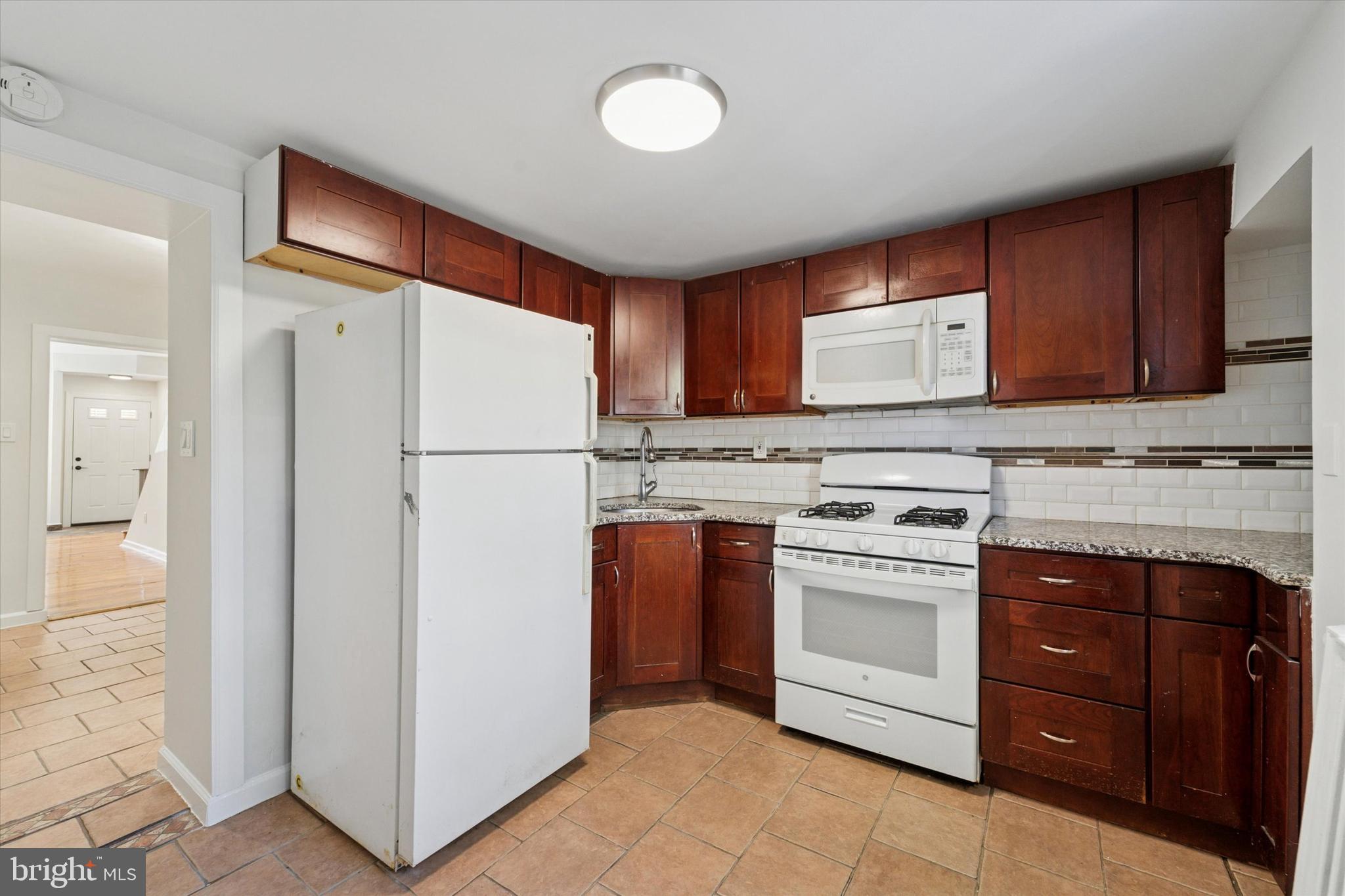 3052 Aramingo Avenue Philadelphia, PA 19134 - Photo 9 of 24 a white refrigerator freezer sitting inside of a kitchen