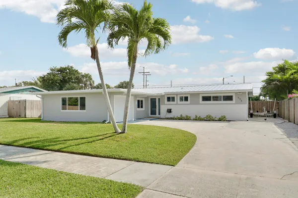a house with palm tree in front of it
