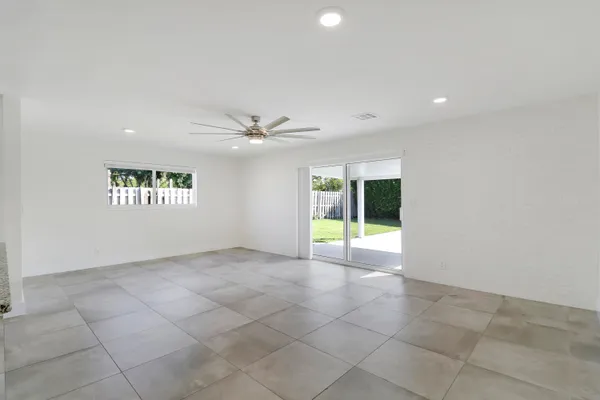 an empty room with a empty space and windows