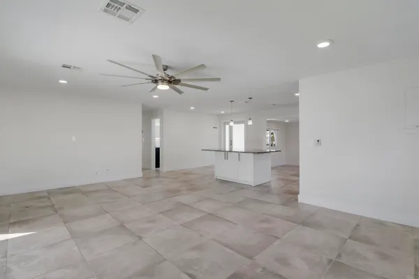 a view of a kitchen with a sink and a ceiling fan