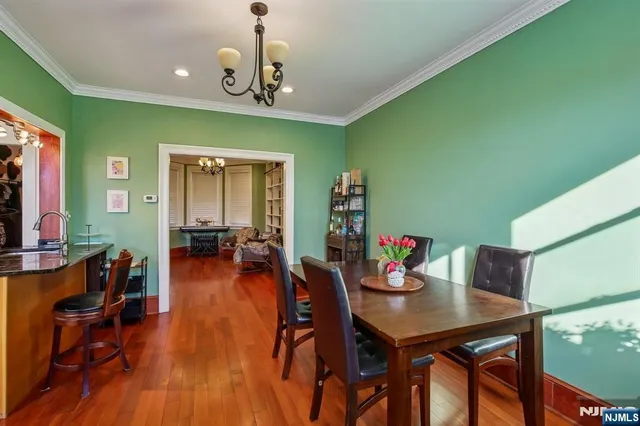 a view of a dining room with furniture wooden floor and a chandelier