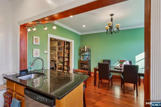 a dining room with furniture and wooden floor
