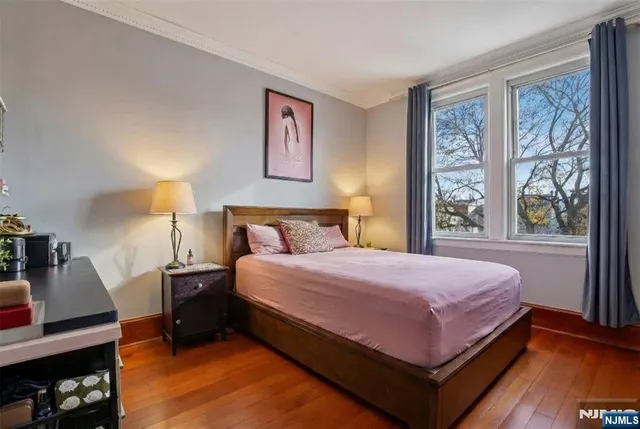 a bedroom with a bed and a night stand