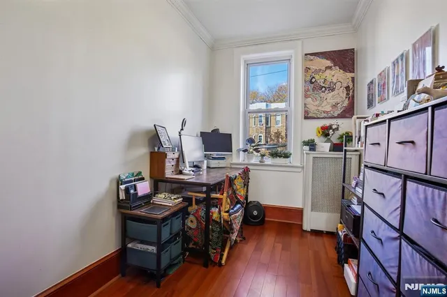 a view of a workspace with furniture and a window