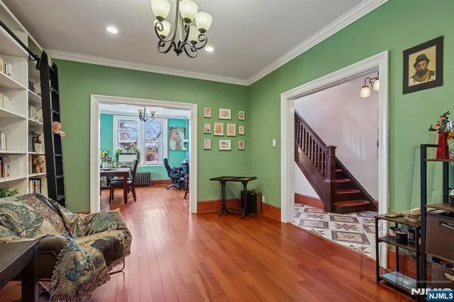 a view of a livingroom with furniture staircase and kitchen view