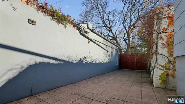 a view of a patio with plants and chairs