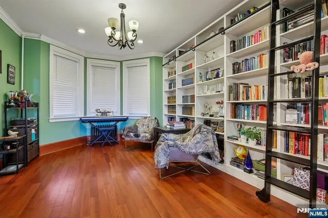 a living room with furniture and a book shelf