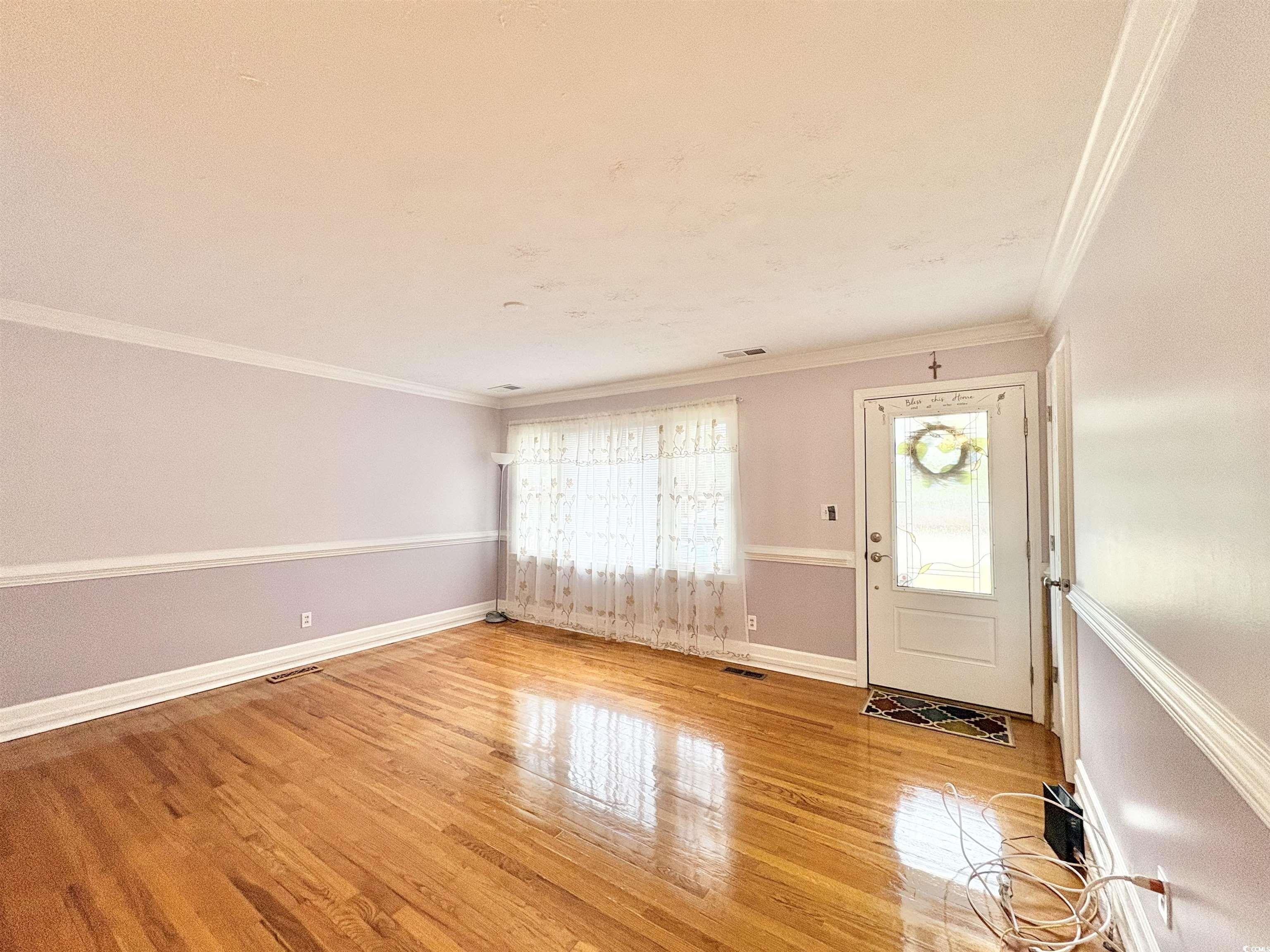 703 62nd Avenue North Myrtle Beach, SC 29577 - Photo 4 of 20 Entryway with crown molding and light wood-type flooring