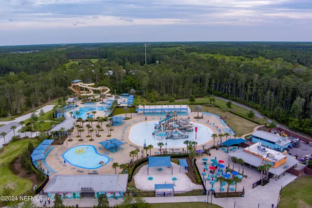 an aerial view of a swimming pool patio and outdoor seating