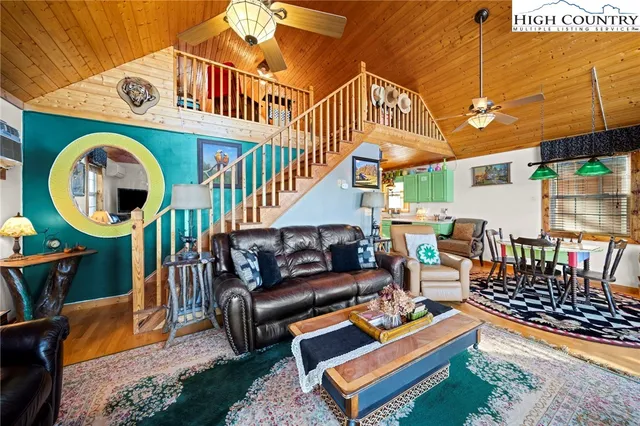 a kitchen filled a sink a counter top space and living room filled with furniture