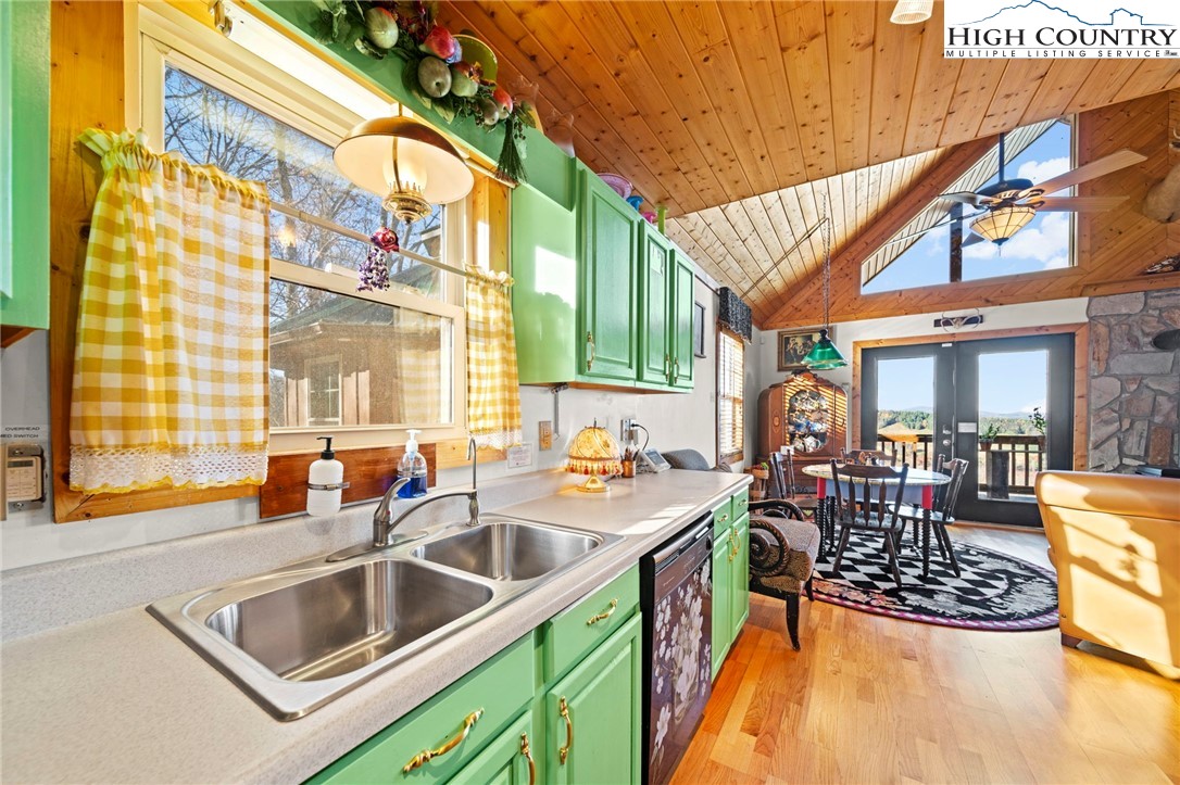 1902 Brown Road Sparta, NC 28675 - Photo 16 of 32 a kitchen filled a sink a counter top space and living room filled with furniture