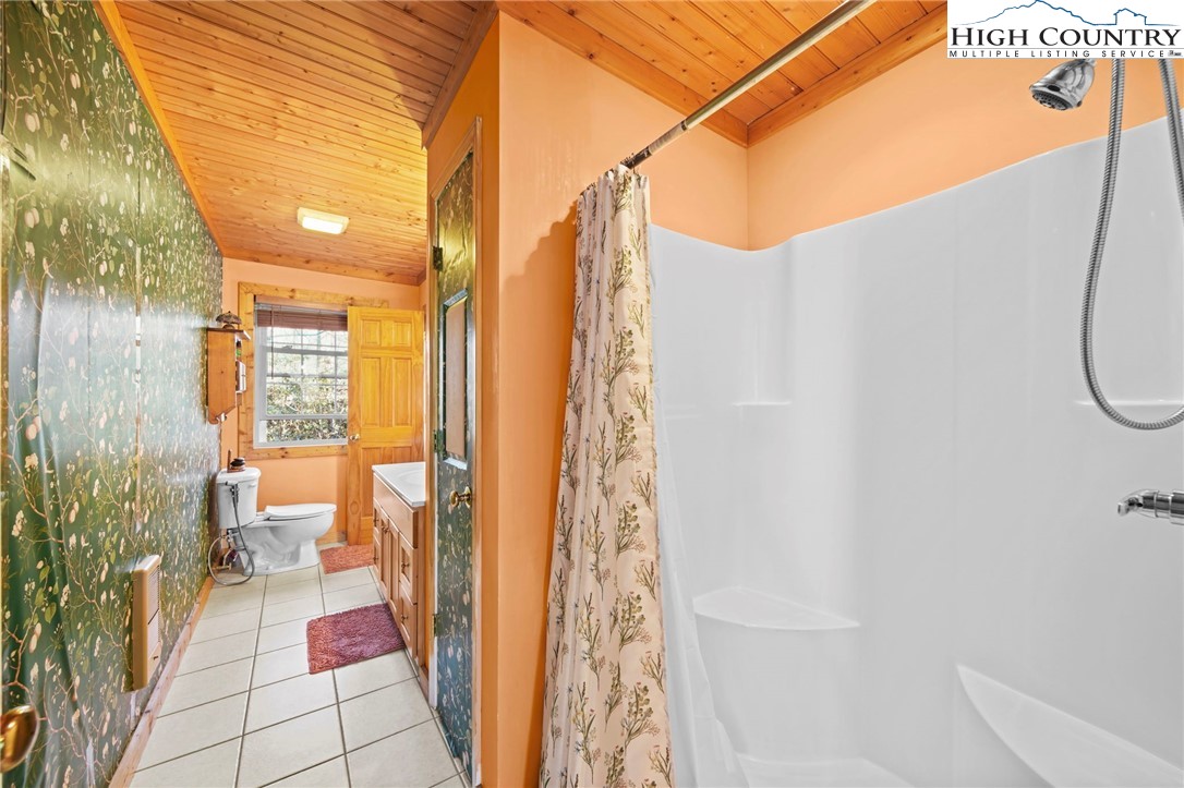 1902 Brown Road Sparta, NC 28675 - Photo 23 of 32 a bathroom with a bathtub and a shower