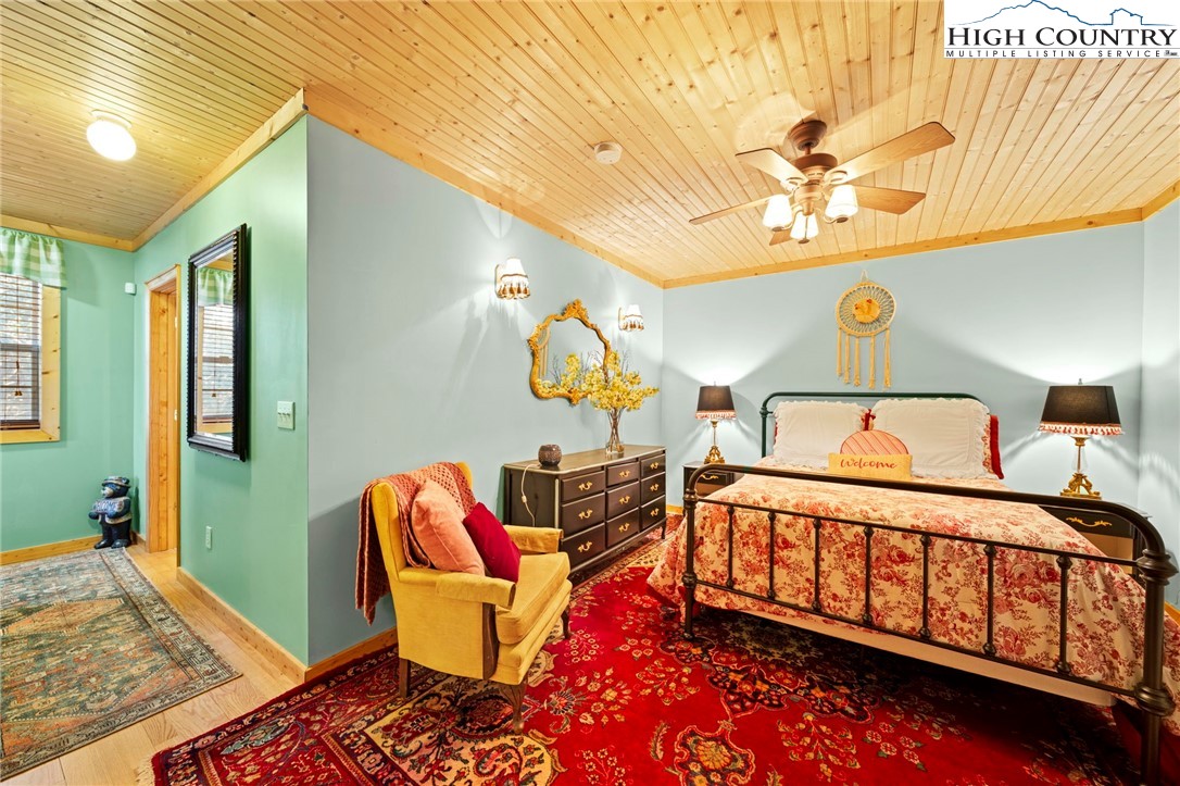 1902 Brown Road Sparta, NC 28675 - Photo 27 of 32 a bedroom with a bed and wooden floor