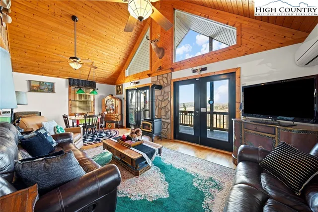 a bedroom with furniture and a flat screen tv