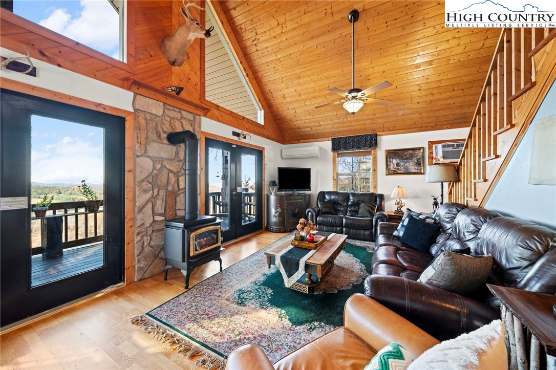 1902 Brown Road Sparta, NC 28675 - Photo 9 of 32 a living room with furniture a flat screen tv and floor to ceiling window