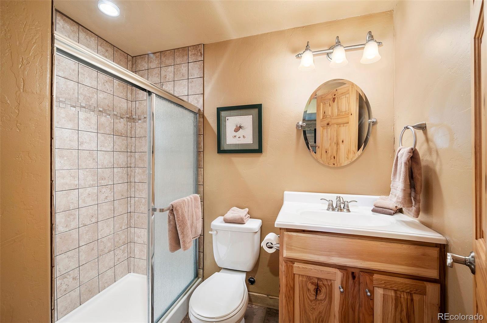 290 Village Road Granby, CO 80446 - Photo 32 of 45 a bathroom with a toilet sink vanity and mirror