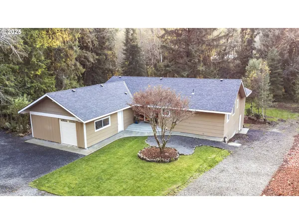 a aerial view of a house in a yard with green space