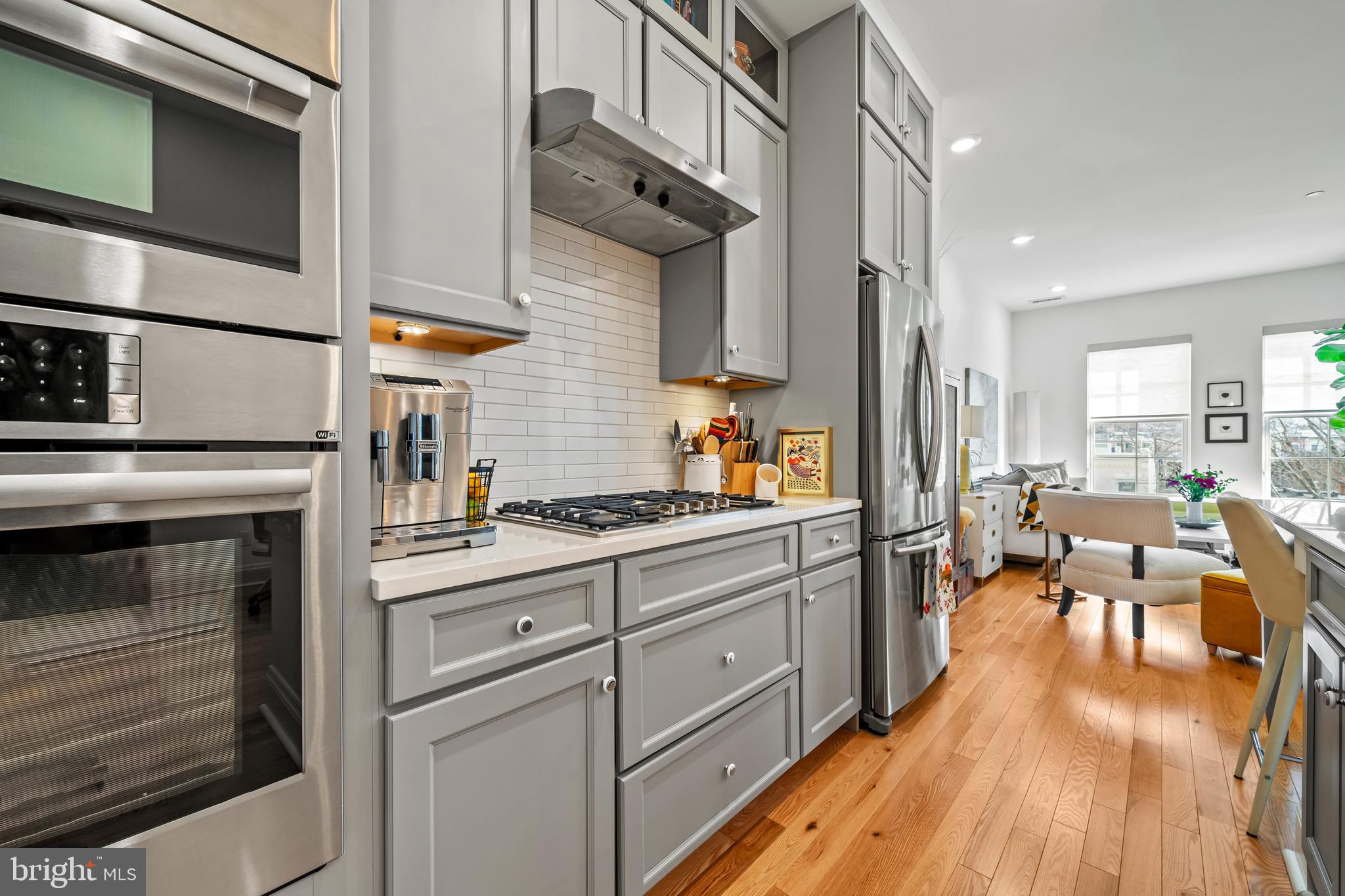 300 8th Street Northeast, Unit 307 Washington, DC 20002 - Photo 4 of 36 a kitchen with stainless steel appliances granite countertop a stove and white cabinets